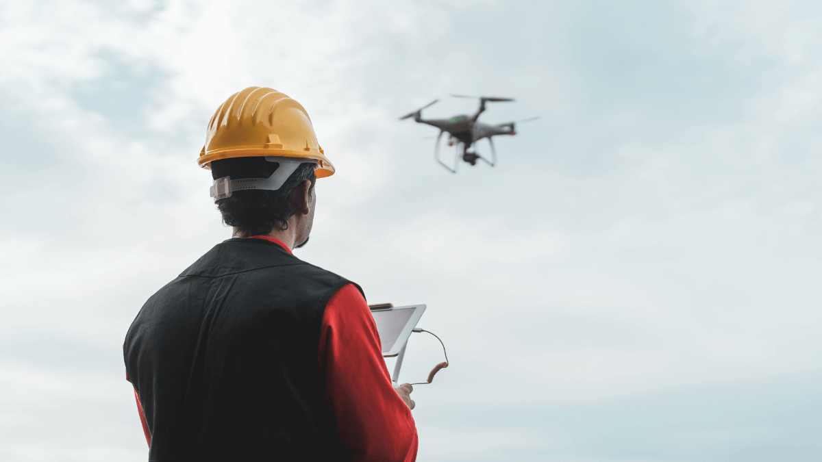 Geospatial thumbnail of someone in a hard hat flying a drone