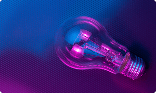 Light bulb glowing with blue and pink, showcasing innovation and creative solutions.